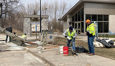 Photo: Crews work on sidewalk at Cass Lake Rest Area.